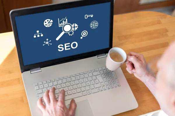 stock image Man using a laptop with seo concept on the screen