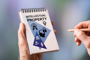 Hand drawing intellectual property concept on a notepad