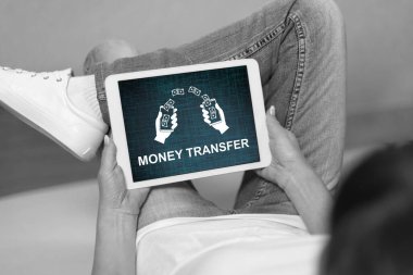 Woman looking at money transfer concept on a tablet
