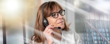 Portrait of female helpline operator in headset; multiple exposure