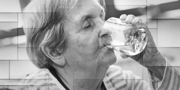Elderly woman drinking water at home, geometric pattern