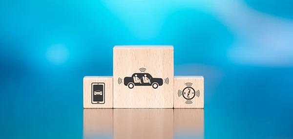 Wooden blocks with symbol of autonomous vehicle concept on blue background