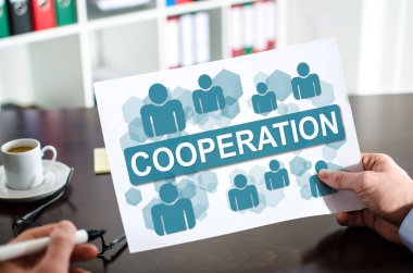 Hand holding a paper showing cooperation concept