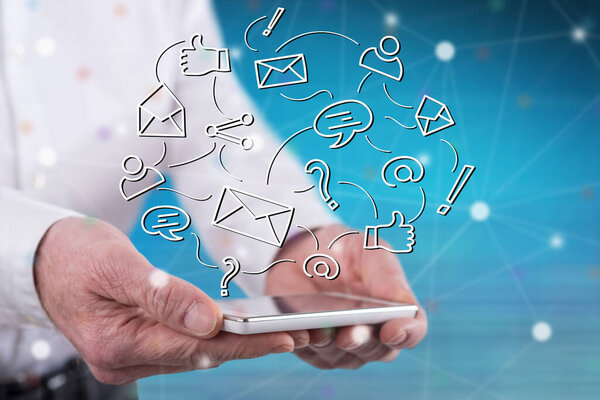 Social network concept above a smartphone held by hands