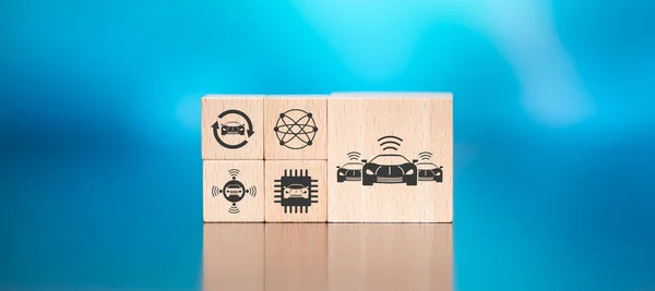 Wooden blocks with symbol of connected cars concept on blue background