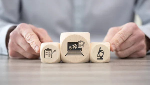 Wooden blocks with symbol of software testing concept