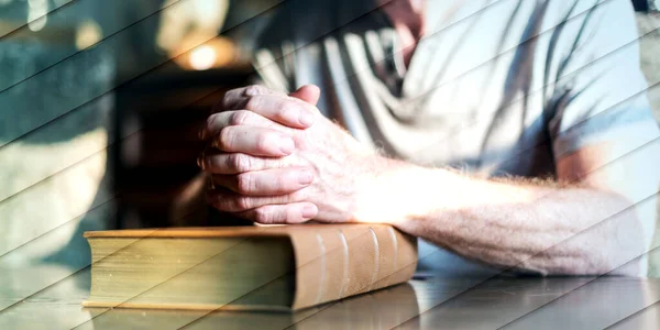 Άνθρωπος Κάθεται Ένα Τραπέζι Προσεύχεται Χέρια Μια Βίβλο Γεωμετρικό Μοτίβο — Φωτογραφία Αρχείου