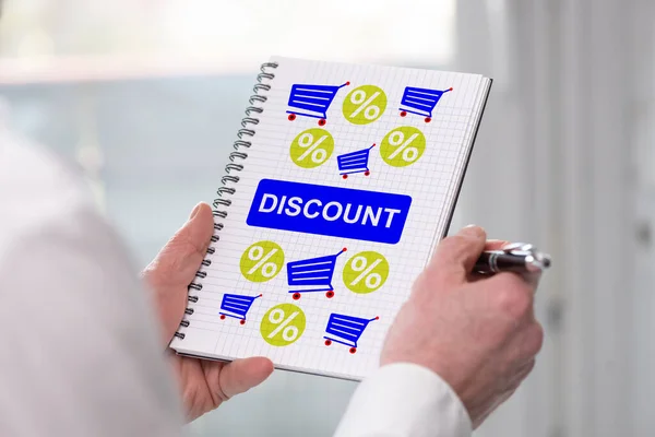 Hand holding a notepad with discount concept