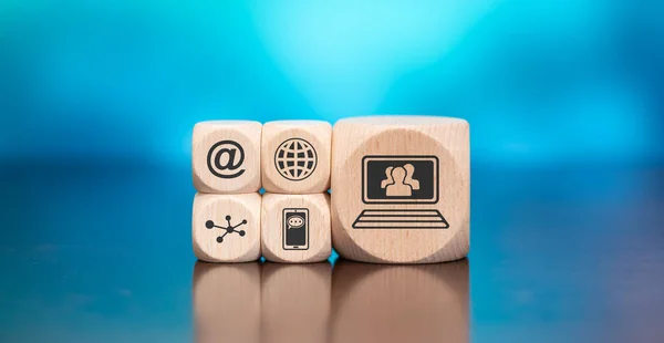 Wooden blocks with symbol of social media concept on blue background