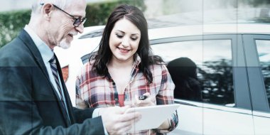 Car salesman giving explanations on tablet to pretty young woman, geometric pattern