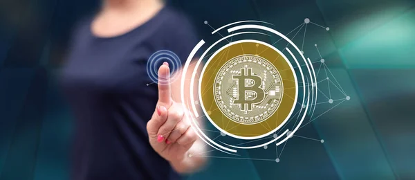 stock image Woman touching a bitcoin currency concept on a touch screen with her finger