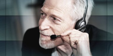 Portrait of senior male helpline operator in headset, geometric pattern