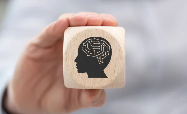 stock image Hand holding a wooden cube with symbol of artificial intelligence concept