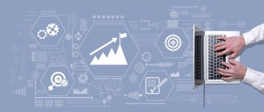 Hedef kavramının sembolü olan dizüstü bilgisayar kullanan ellerin üst görünümü