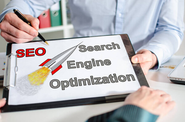 Бизнесмен показывает концепцию SEO в буфере обмена
