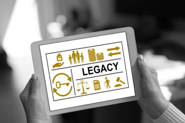 Legacy concept shown on a tablet held by a woman clipart