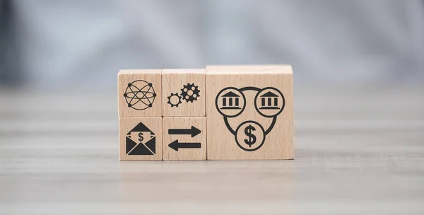 Wooden blocks with symbol of money transfer concept