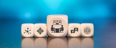 Wooden blocks with symbol of teleconference concept on blue background