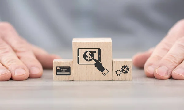 Wooden blocks with symbol of mobile payment concept