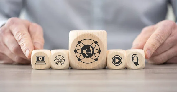 Wooden blocks with symbol of digital advertising concept