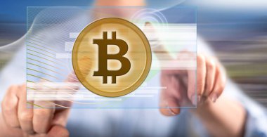 Kadın parmaklarıyla dokunmatik ekranda para birimine dokunuyor.