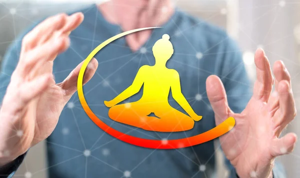 Meditation concept between hands of a man in background