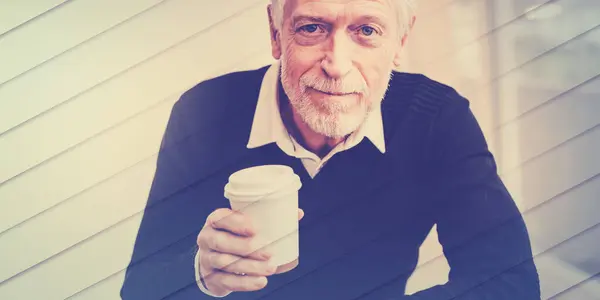 Man having coffee break at home, geometric pattern