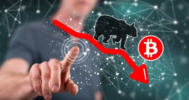 Dokunmatik ekranda bir bitcoin 'e dokunan adam ayı eğilimi kavramına parmağıyla dokunuyor