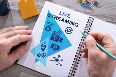 Masaya yerleştirilmiş bir not defterine canlı yayın konsepti