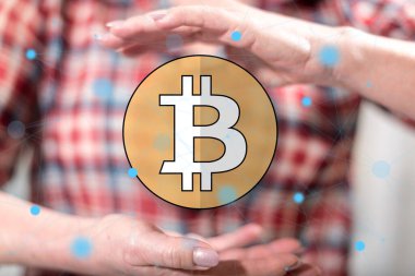 Arka planda bir kadının elleri arasında Bitcoin kavramı