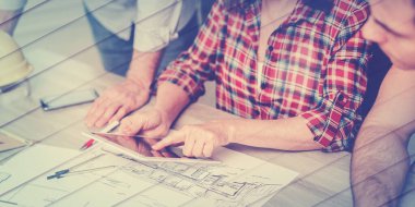 Architects working on plans at office, geometric pattern