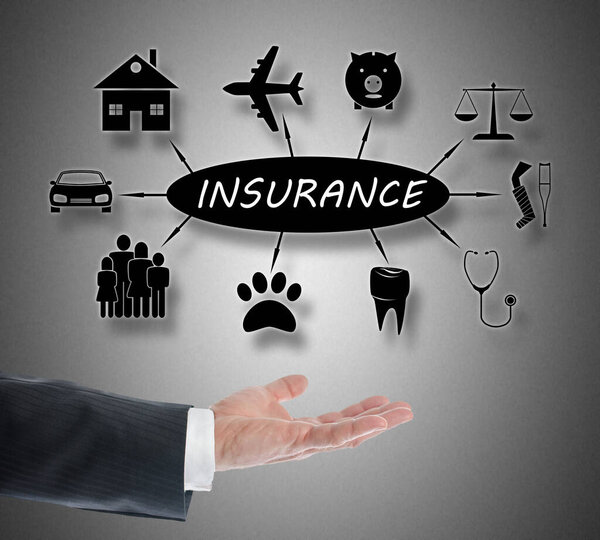 Insurance concept levitating above a hand on grey background