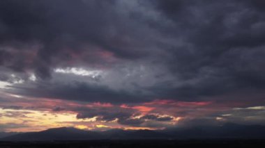 Güneşin altın ışıklarıyla gün batımının güzel manzarası dağ manzarasının siluetinin arka planına karşı. Doğal manzara arka planı.