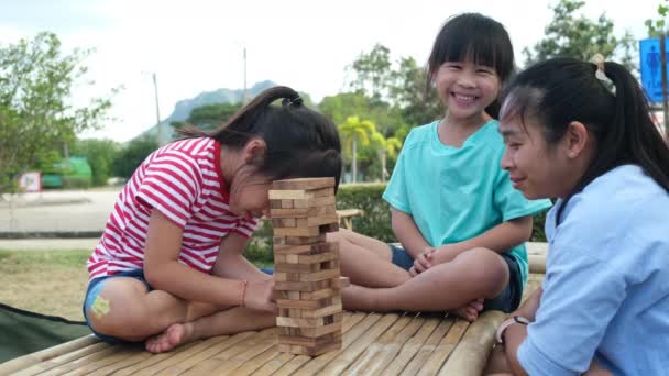 Excited Kids Mom Playing Jenga Tower Wooden Block Game Together — Stock video