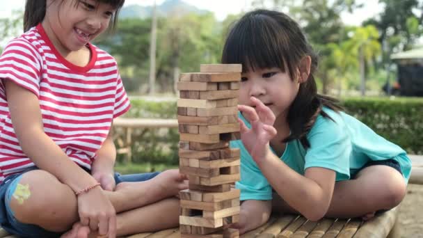Excited Kids Mom Playing Jenga Tower Wooden Block Game Together — Vídeo de stock