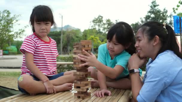 Excited Kids Mom Playing Jenga Tower Wooden Block Game Together — Stok video