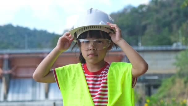 Portrait Little Girl Engineer Wearing Green Vest White Helmet Smiling — Video Stock