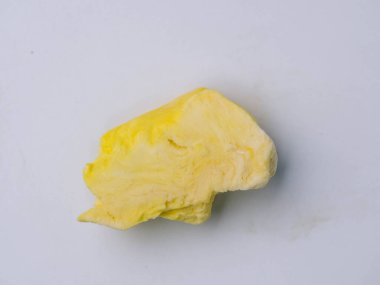 Freeze-dried durian, is a processed fruit that retains the nutritional value of food. A piece of freeze-dried durian isolated on white background. Clipping path.