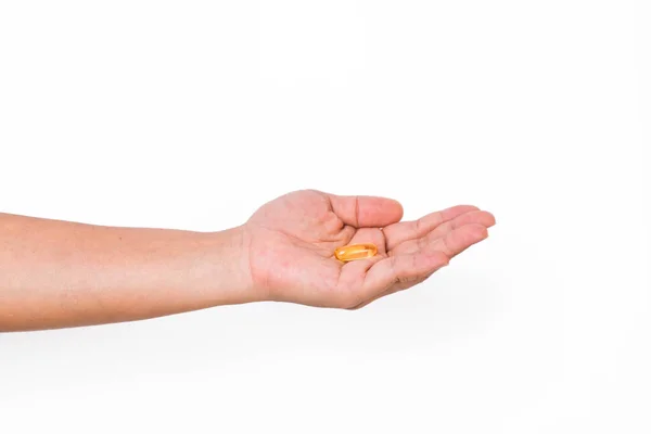 stock image Hand holding a capsule or pill isolated on white background.