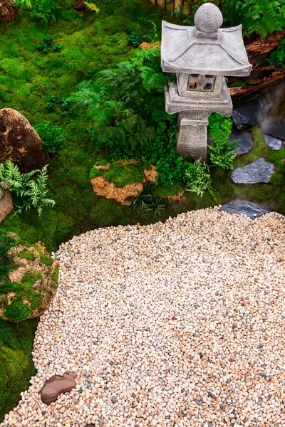 stock image Minimal Japanese garden in home with small stone lantern and bamboo fountain and moss and flowers.