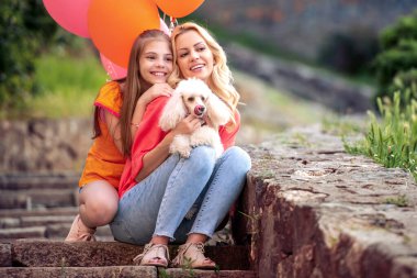 Mother and daughter having fun in the park.Family,nature,love and happiness concept.