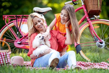 Mother and daughter having fun in the park.Family,nature,love and happiness concept.