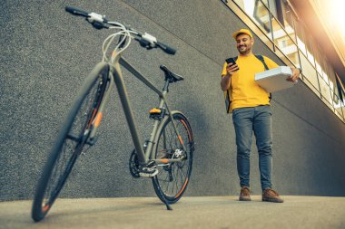 Food delivery service, man delivering food with bicycle.Courier delivering food on a bike.Pizza.