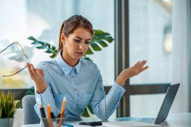 Businesswoman working in the office.Frustrated stressed business woman in office.