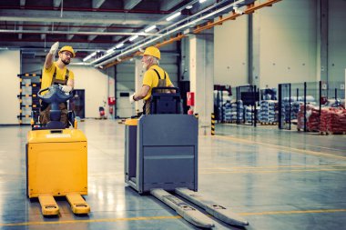Forklift kullanan depo işçileri. Raflarla dolu karton kutularla dolu perakende teslimat deposu. Ürün çizimi ve teslimat lojistiği..