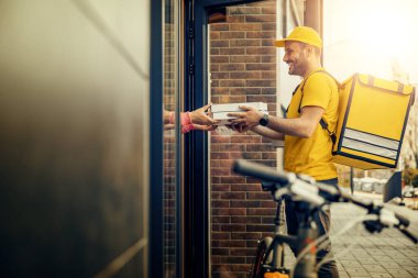 Young man in uniform as a courier delivering food.Food delivery.