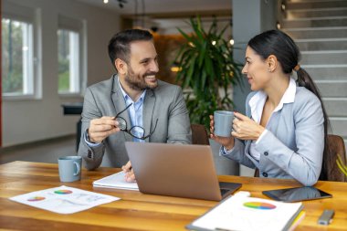 Ofisteki iki iş arkadaşı yeni yatırımların iş stratejisini tartışıyor. Masada birlikte oturan başarılı iş adamları..