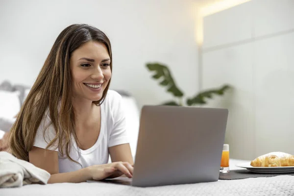 Woman using laptop, writing email,online meeting or payment online.Freelancer working from home office.