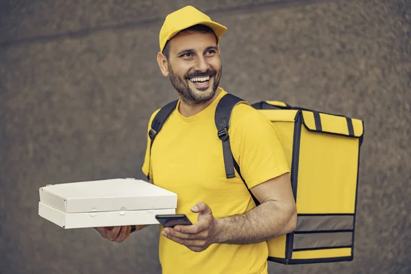 Fast delivery service concept. Courier delivering boxes with pizza.