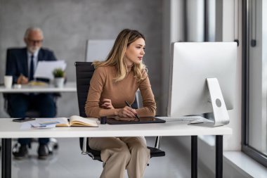 Yaratıcı insanlar bir ofiste dizüstü bilgisayar kullanarak buluşuyor ve yeni planlar hakkında konuşuyorlar. Web tasarımcıları ofiste çalışıyor ve yeni web sitesi planlıyorlar..